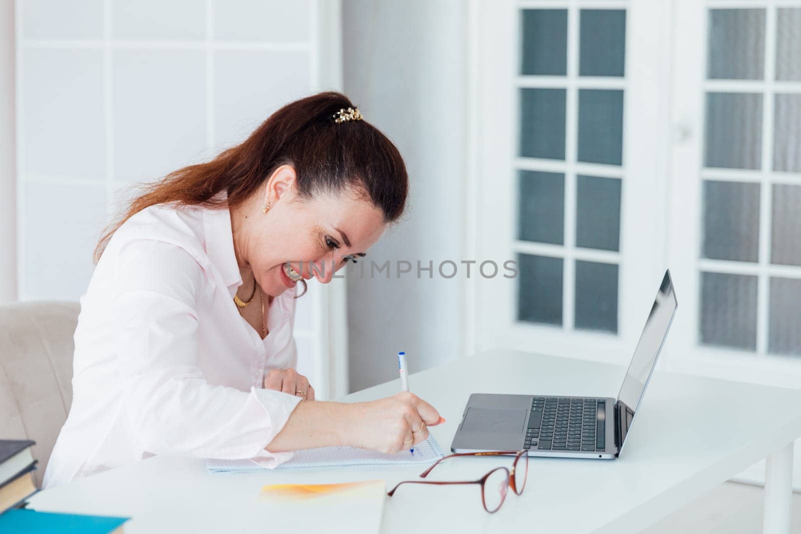 Beautiful woman working at computer small business finance by Simakov