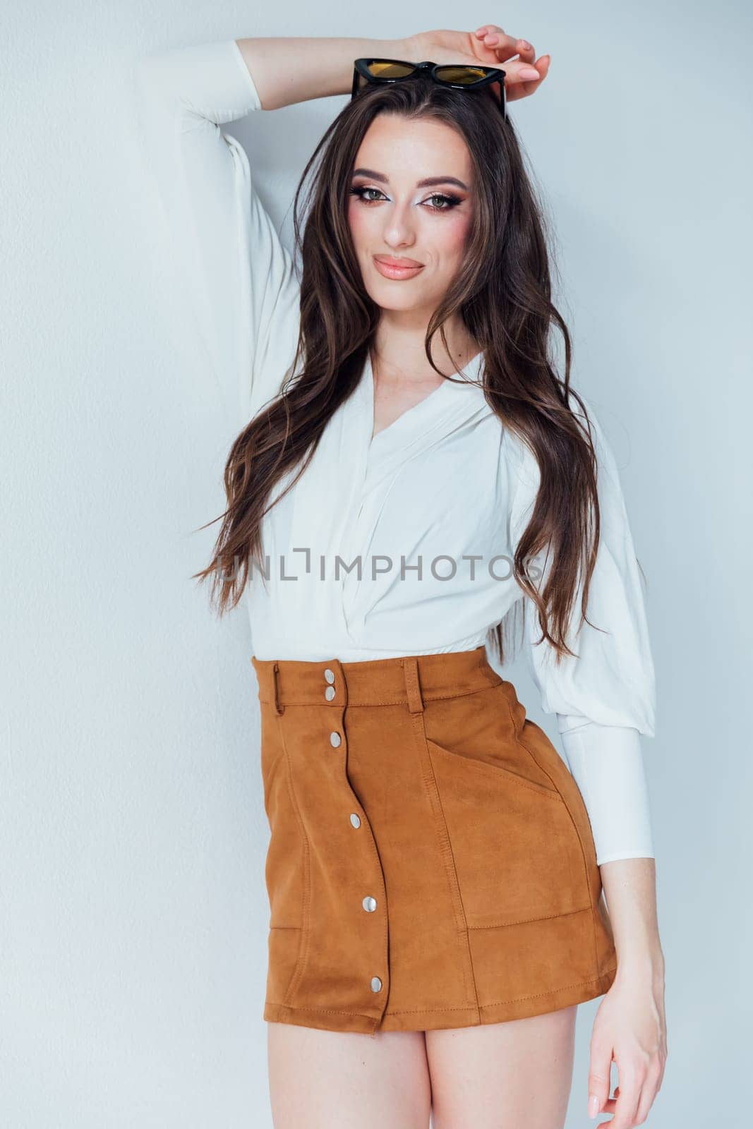 Beautiful fashionable woman in blouse and yellow skirt on white background