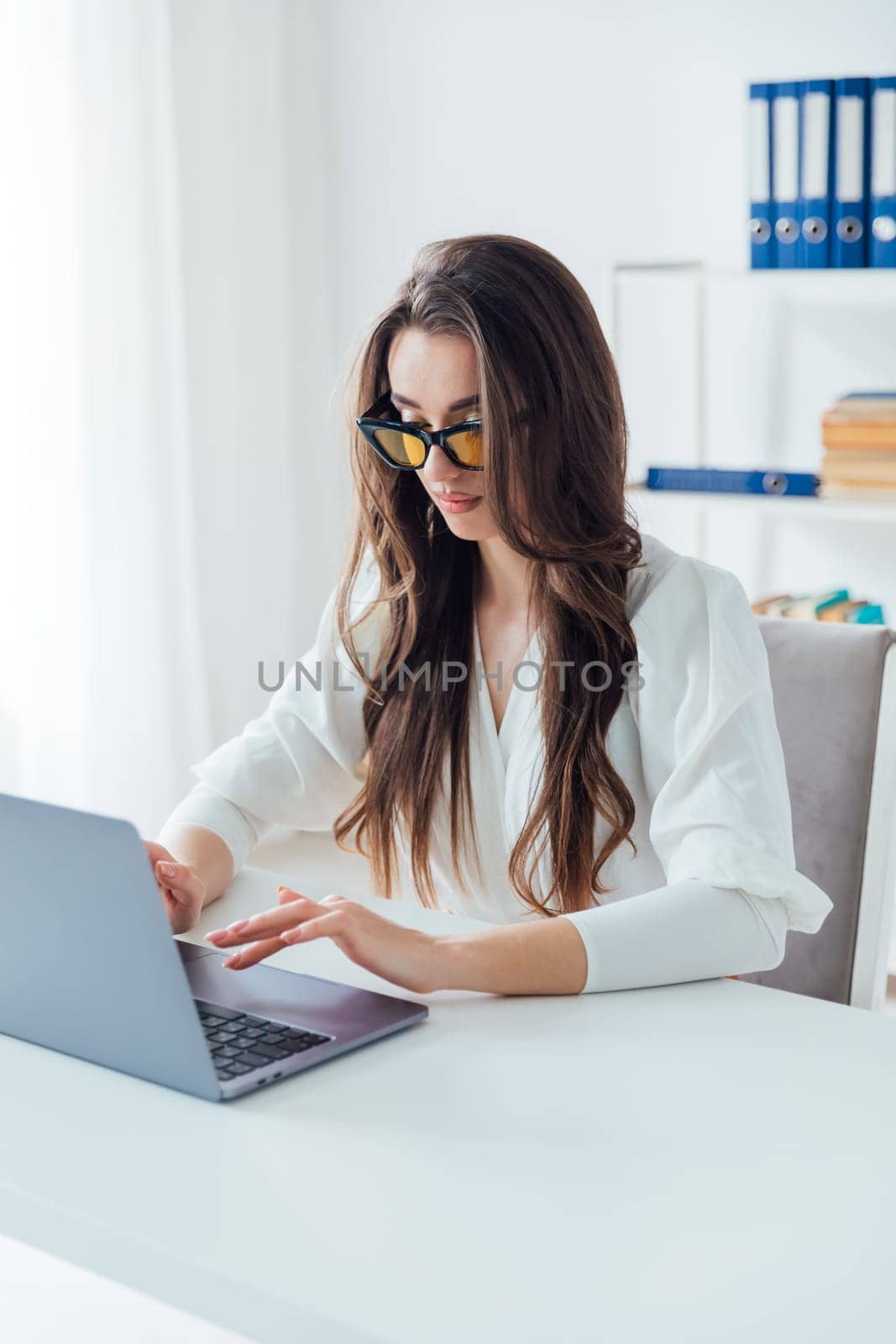 Businesswoman working on laptop in office finance business online by Simakov