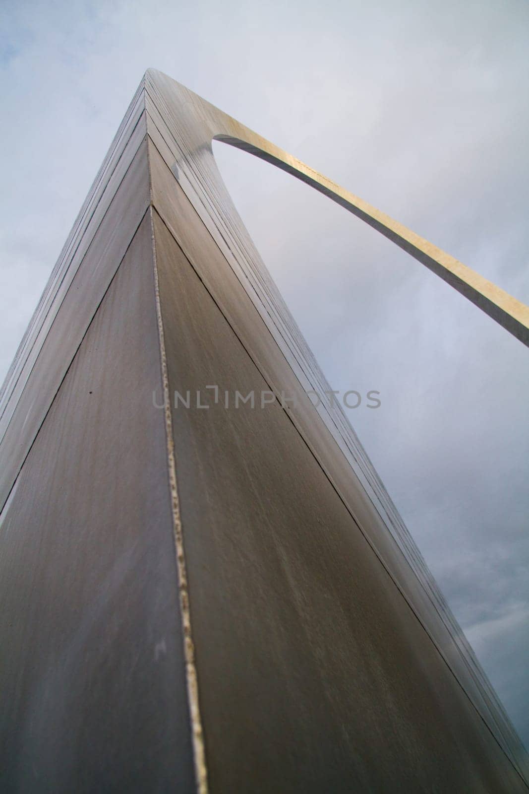 Iconic St. Louis Arch: Captivating modern architecture rises above the clouds, showcasing sleek stainless steel and clean lines. A symbol of innovation and urban development in Missouri.