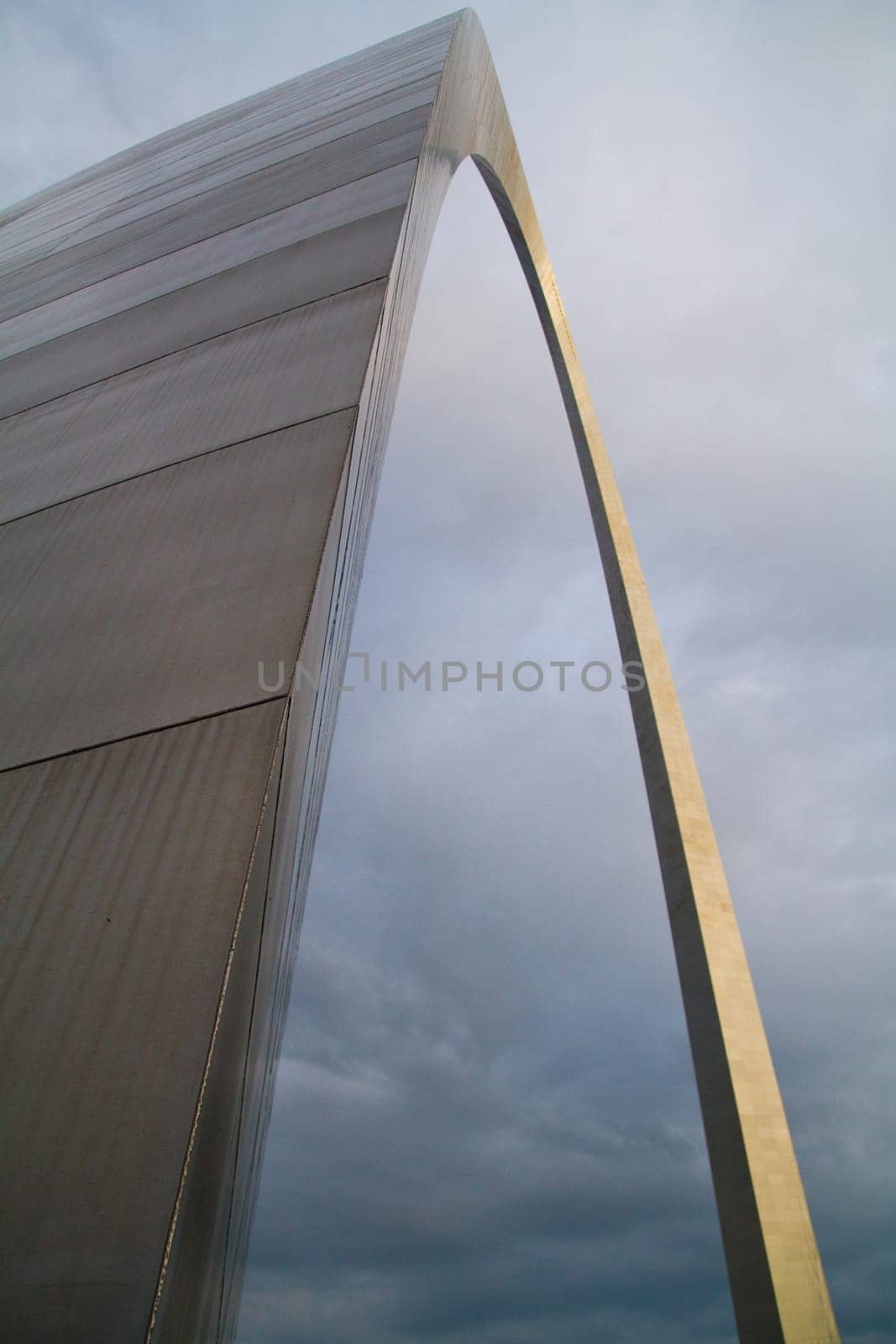 Reflective Steel Arch Against Moody Sky in St. Louis by njproductions