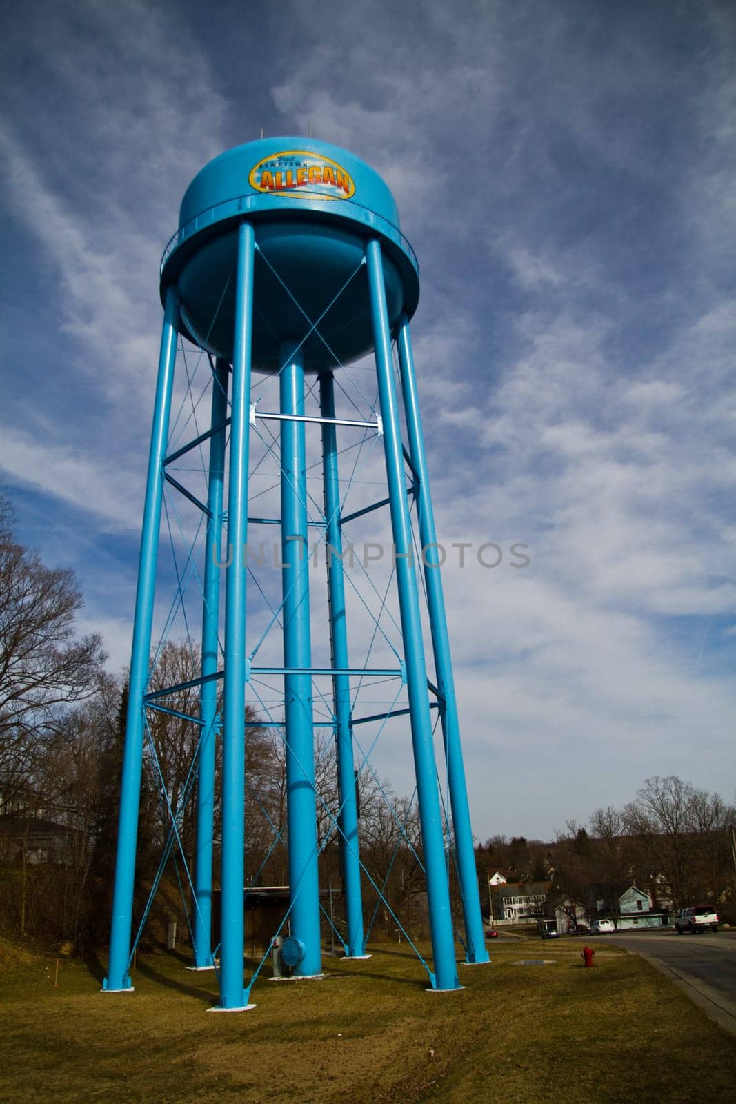 Blue Allegan Water Tower Against Dynamic Sky in Semi-Rural Community by njproductions