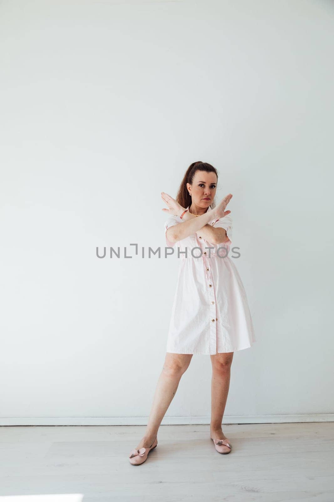 Brunette woman 40 years old in light light summer dress by Simakov