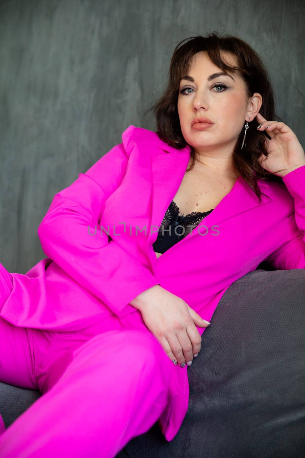 Beautiful fashionable woman in crimson stylish suit by Simakov