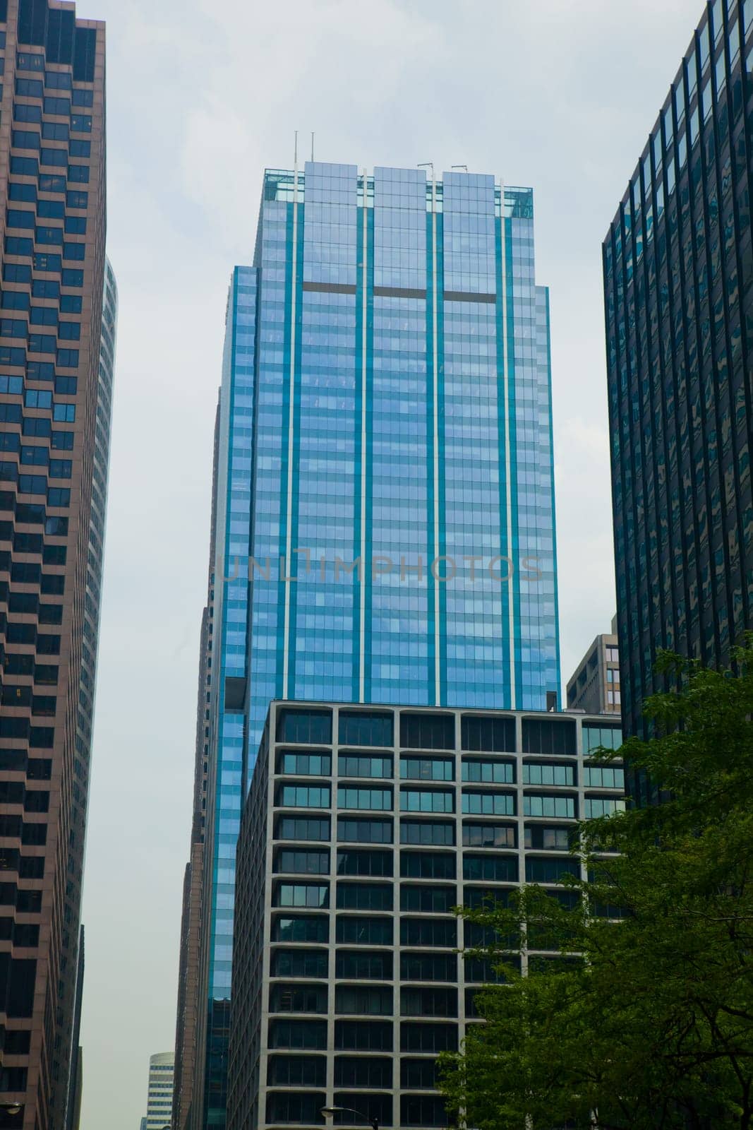 Dynamic Chicago skyline featuring iconic glass skyscraper amidst bustling cityscape, showcasing modern architecture and urban development in the vibrant financial district.