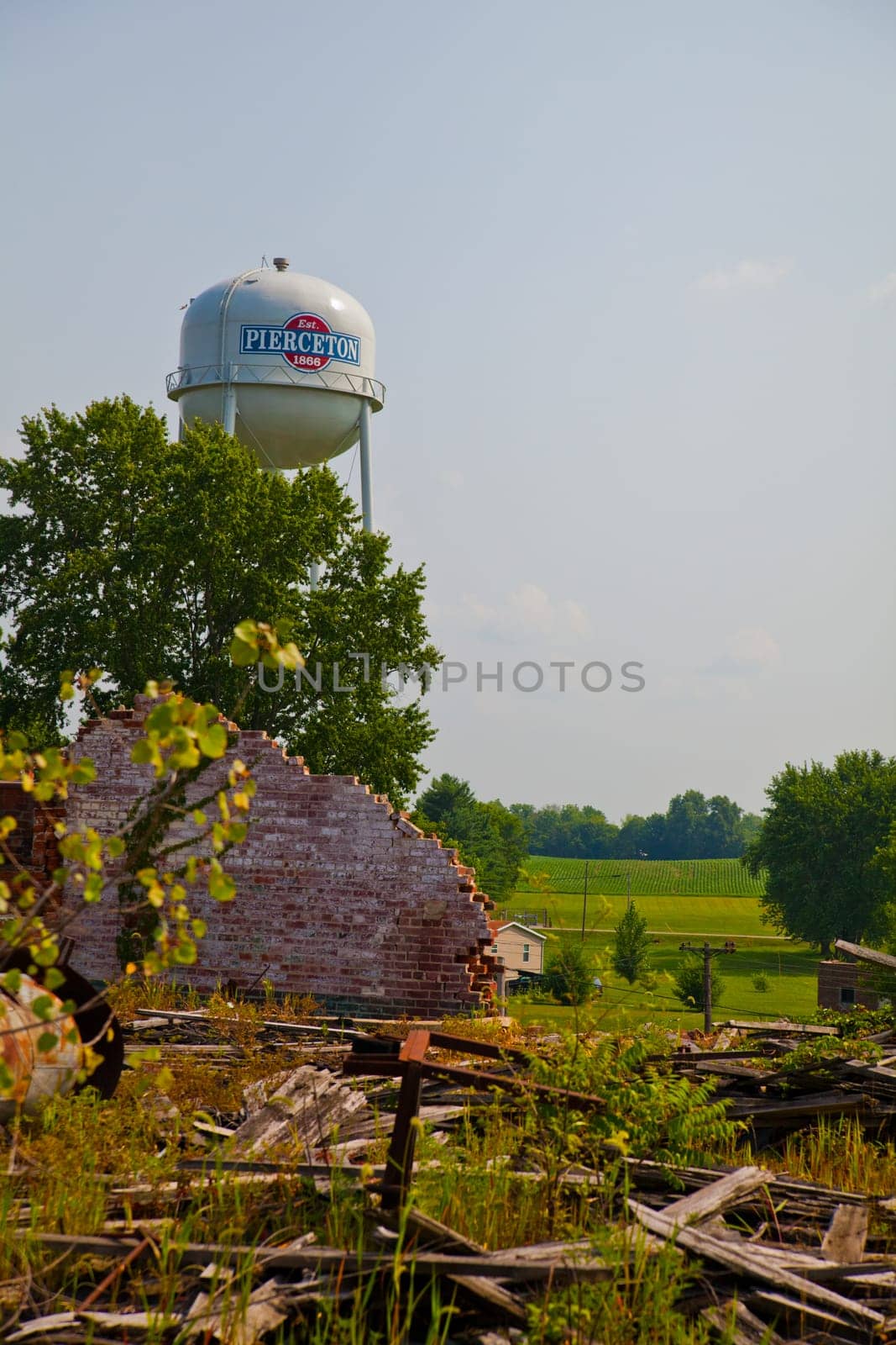 Pierceton contrasting landscapes: A haunting reminder of history's decay juxtaposed with the resilience of a proud small-town water tower.