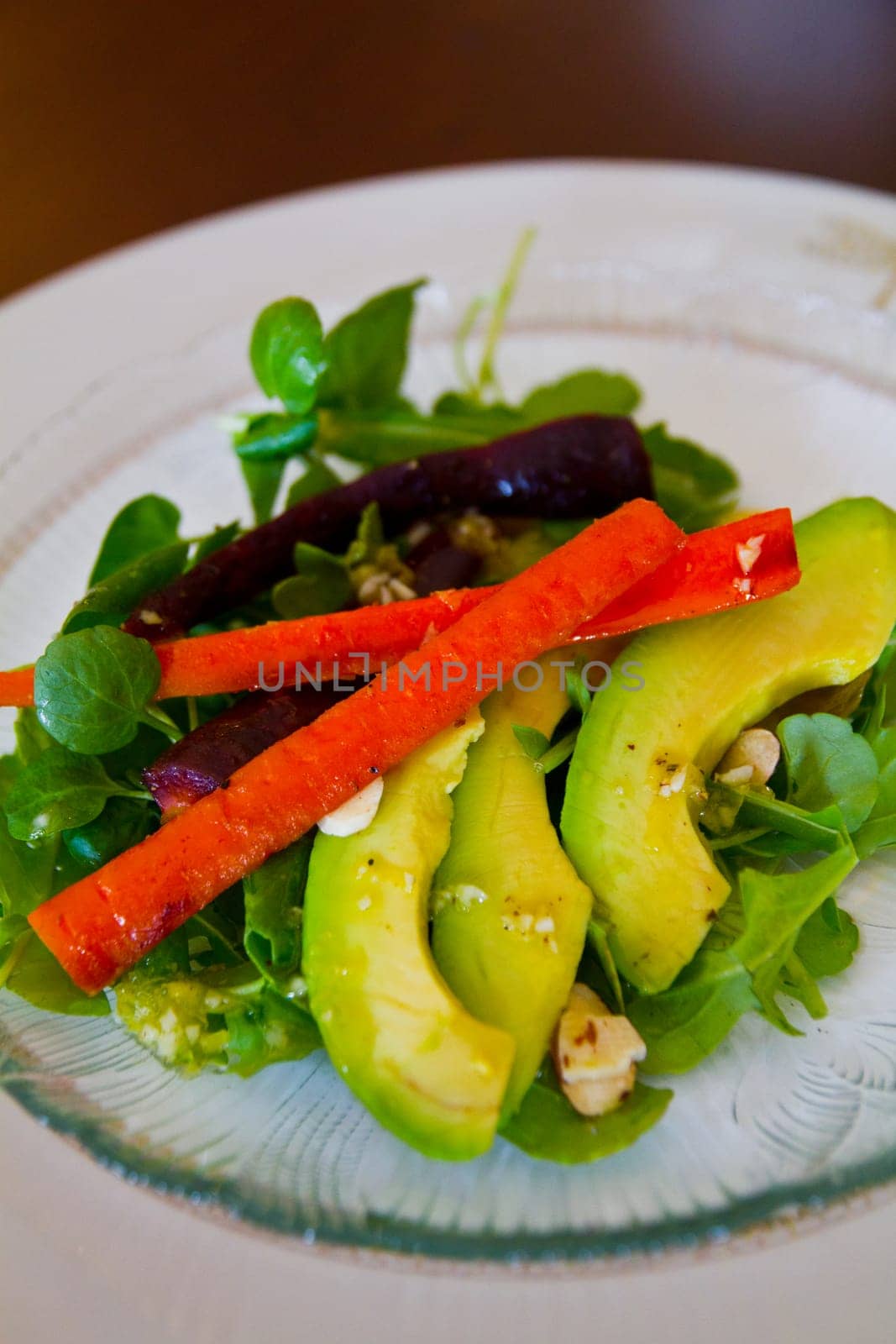 Vibrant Fresh Salad with Avocado and Carrot in Indoor Setting by njproductions