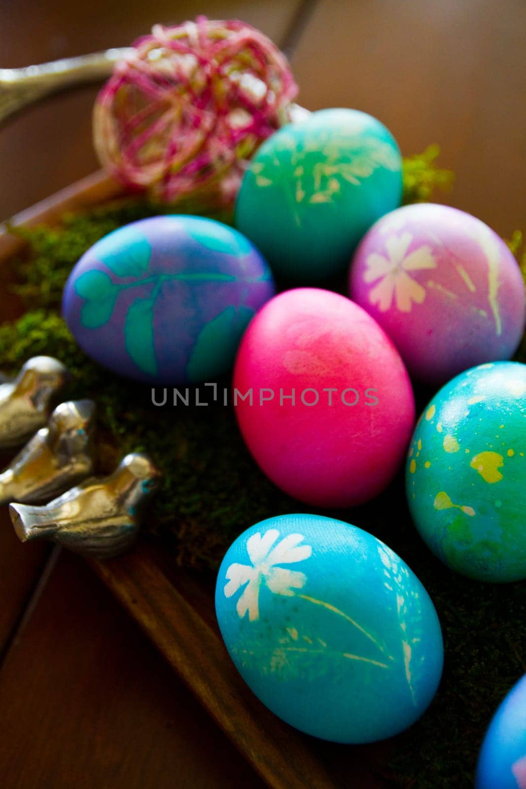 Easter egg extravaganza! Colorful and vibrant eggs adorned with intricate patterns rest on a bed of lush green moss, creating a festive ambiance. Perfect for spring celebrations and holiday decorations. Fort Wayne, Indiana.