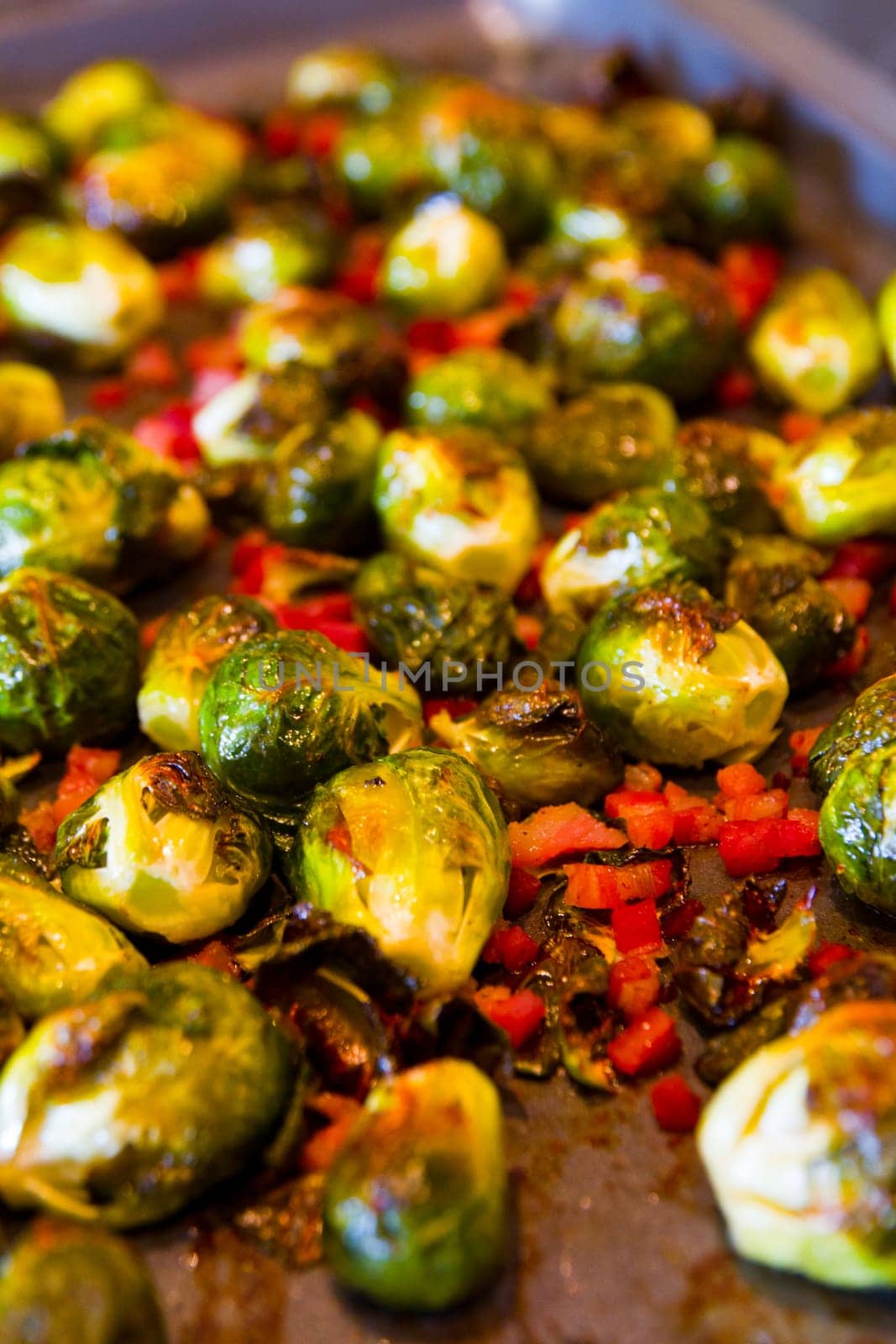 Deliciously Roasted Brussels Sprouts with Vibrant Red Bell Pepper - A mouthwatering and healthy vegetarian dish showcasing perfectly caramelized brussels sprouts and colorful bell peppers. Ideal for food blogs and recipe websites.