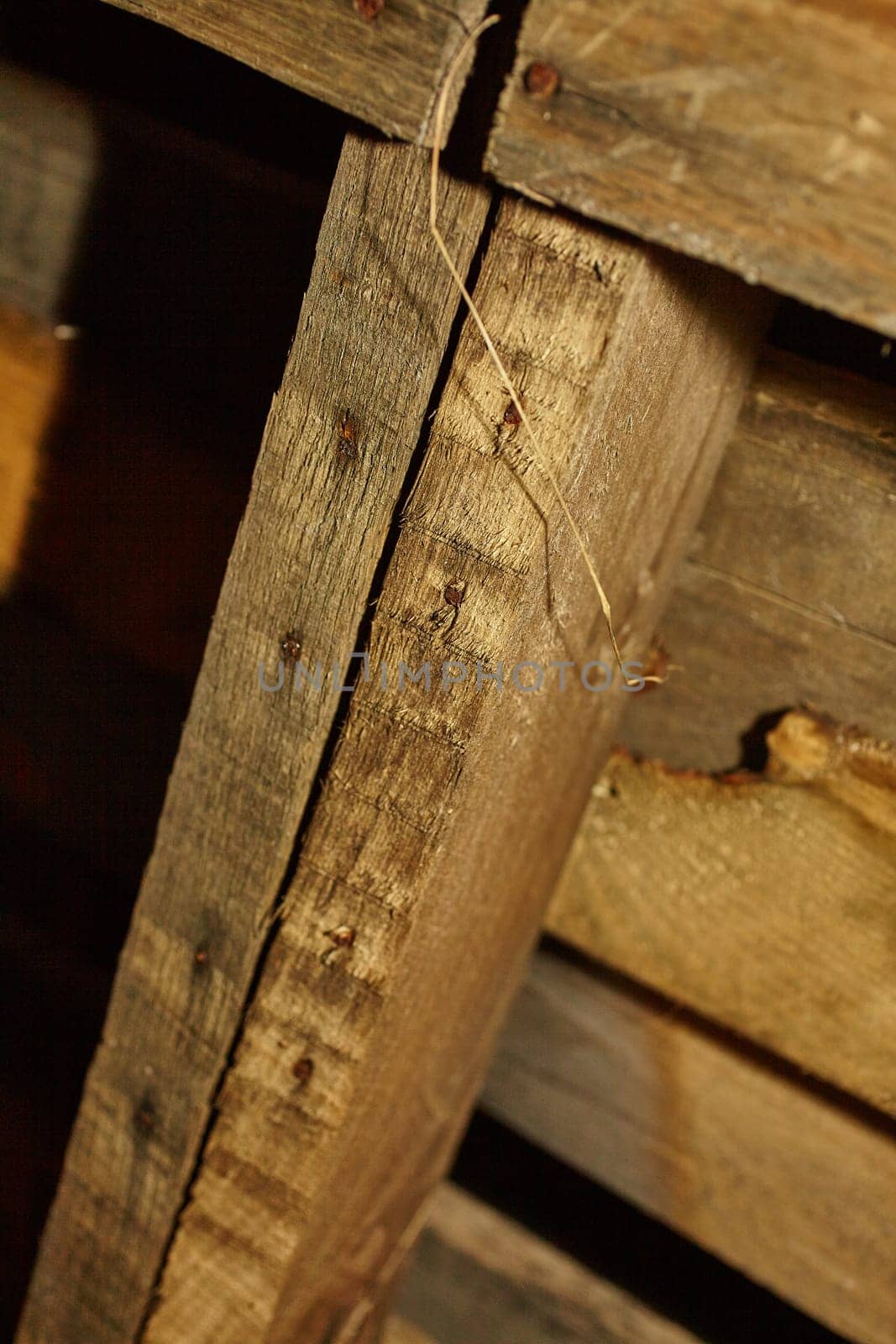 Authentic vintage wooden beams with a rustic texture and rich golden-brown color, showcasing history and durability. Captivating angles and rough grain patterns add depth and character. Ideal for interior design and historical renovation.