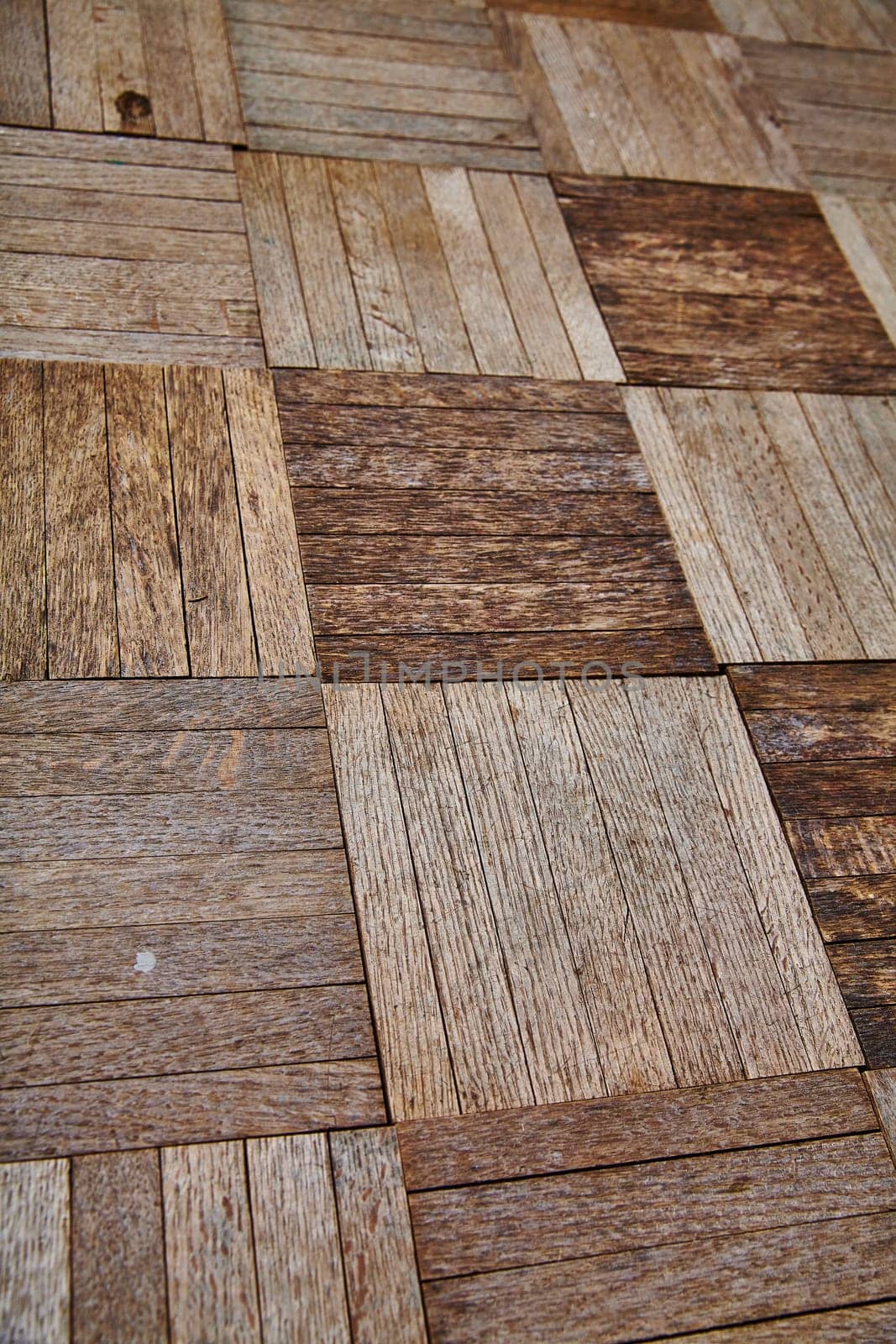 View of Rustic Herringbone Wood Flooring Texture in Warm Tones Close-Up by njproductions