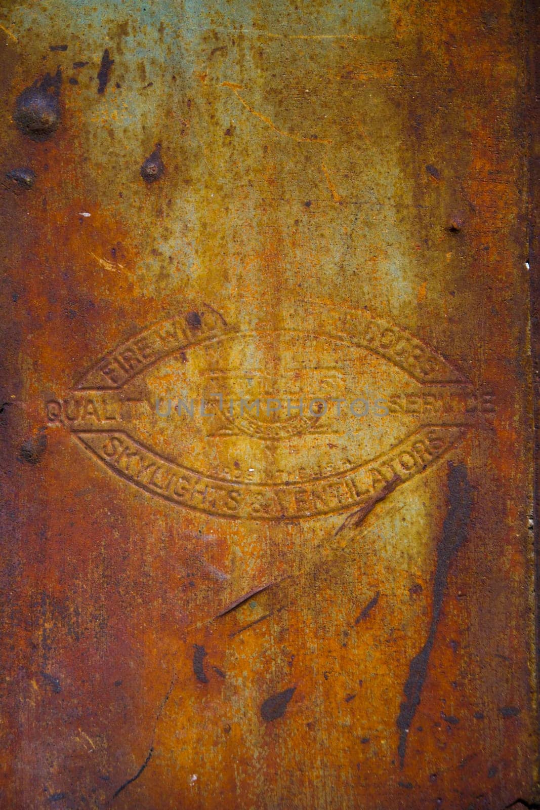 Embossed Emblem on Rusted Metal at Abandoned Illinois Plant Background by njproductions