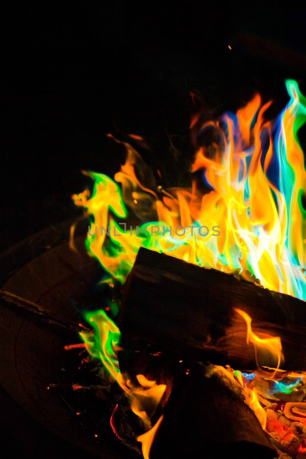 Vibrant Multicolored Campfire Flames in Outdoor Setting close-up silhouette by njproductions