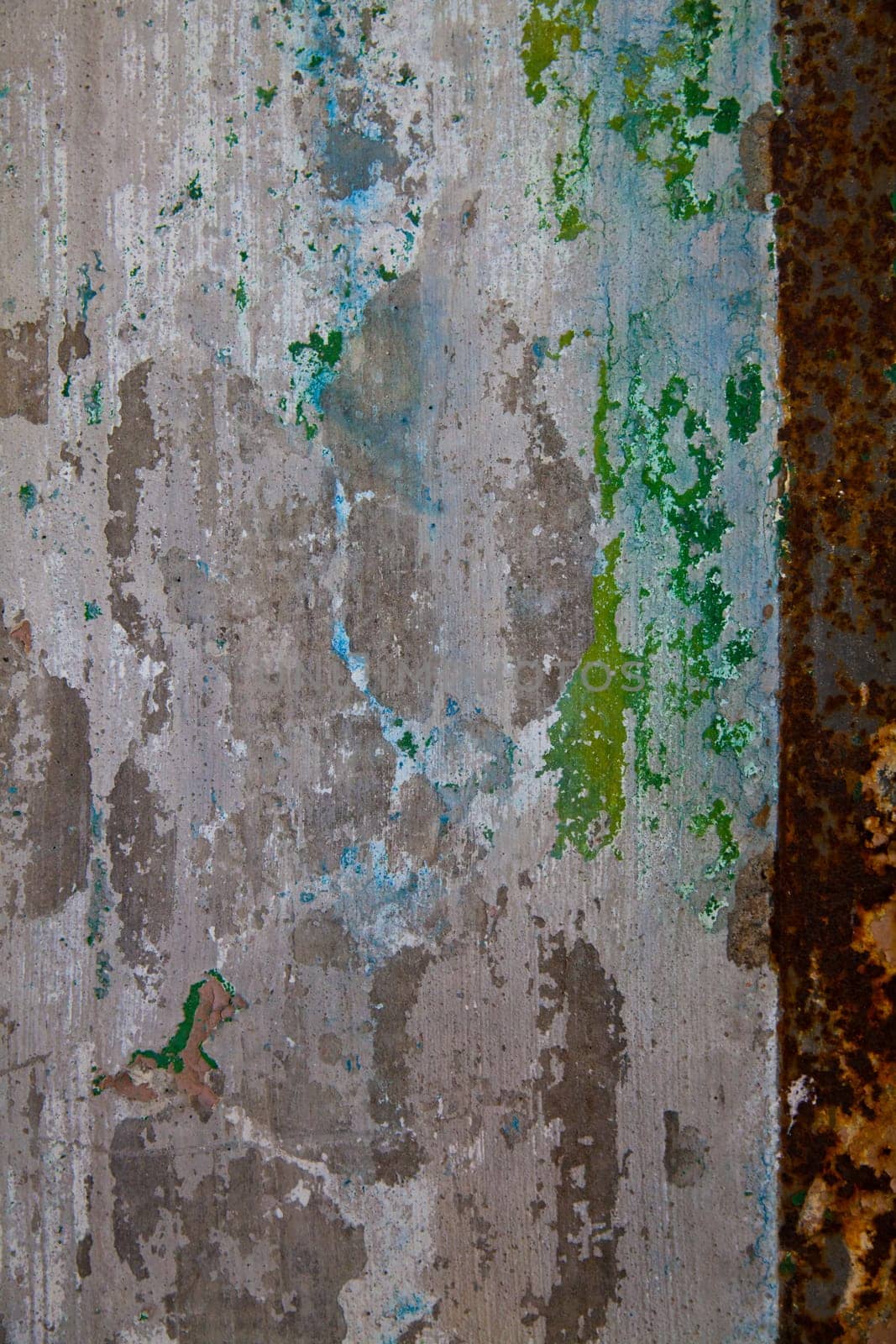Weathered metal sheet with peeling paint and rust, showcasing the passage of time and nature's relentless decay. Industrial grunge texture from the abandoned Pierceton Factory in Indiana.