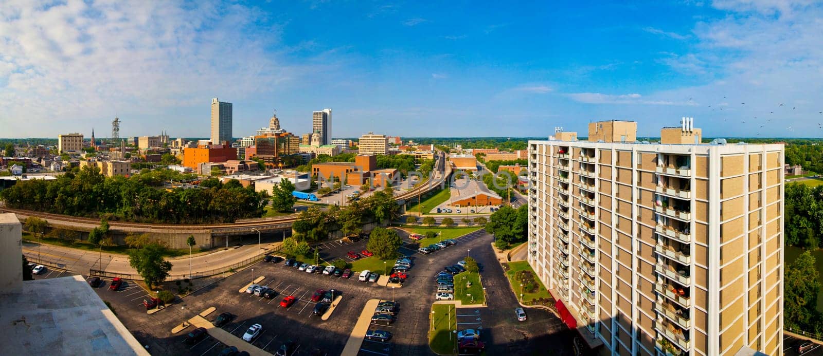 Dynamic urban growth and connectivity: A panoramic view of Fort Wayne, Indiana's skyline, blending modern high-rises with traditional architecture. From corporate hubs to sustainable living, this bustling cityscape captures the essence of business.