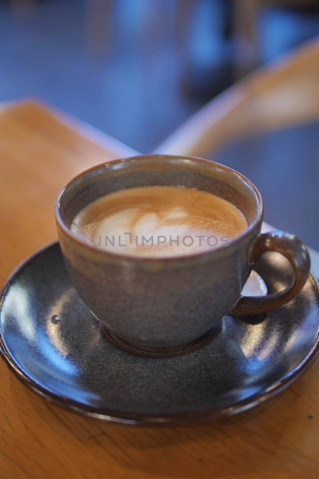 Coffee cup on wood table .