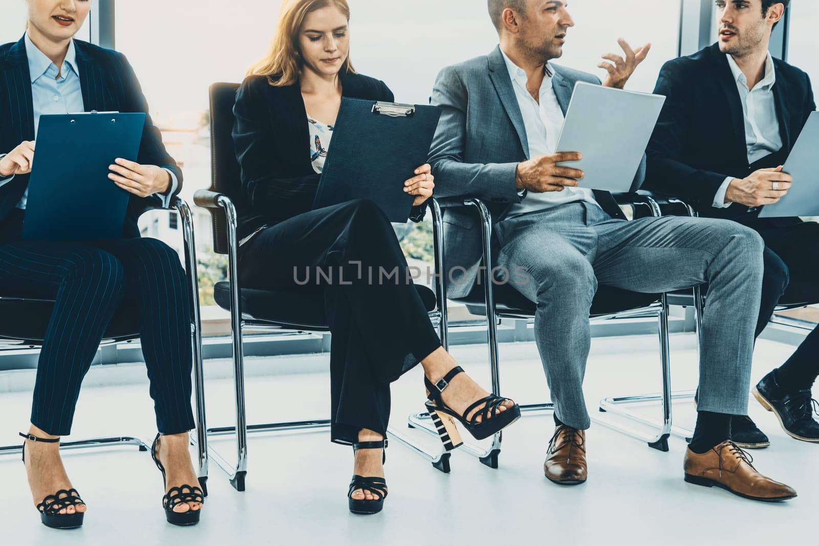 Businesswomen and businessmen wait for interview. uds by biancoblue