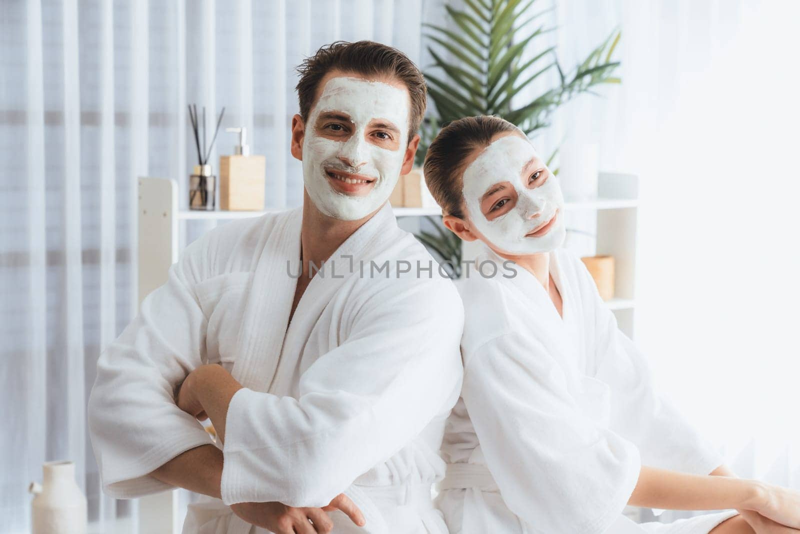 Blissful couple in bathrobe with facial cream mask. Quiescent by biancoblue