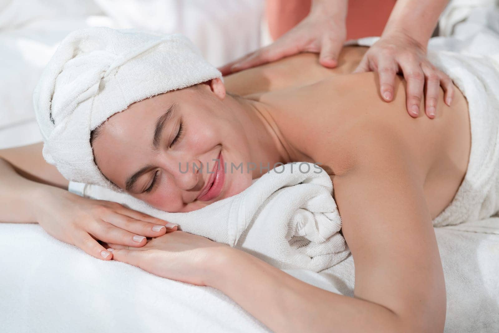 Attractive caucasian woman having back massage by masseur. Closeup. Tranquility. by biancoblue