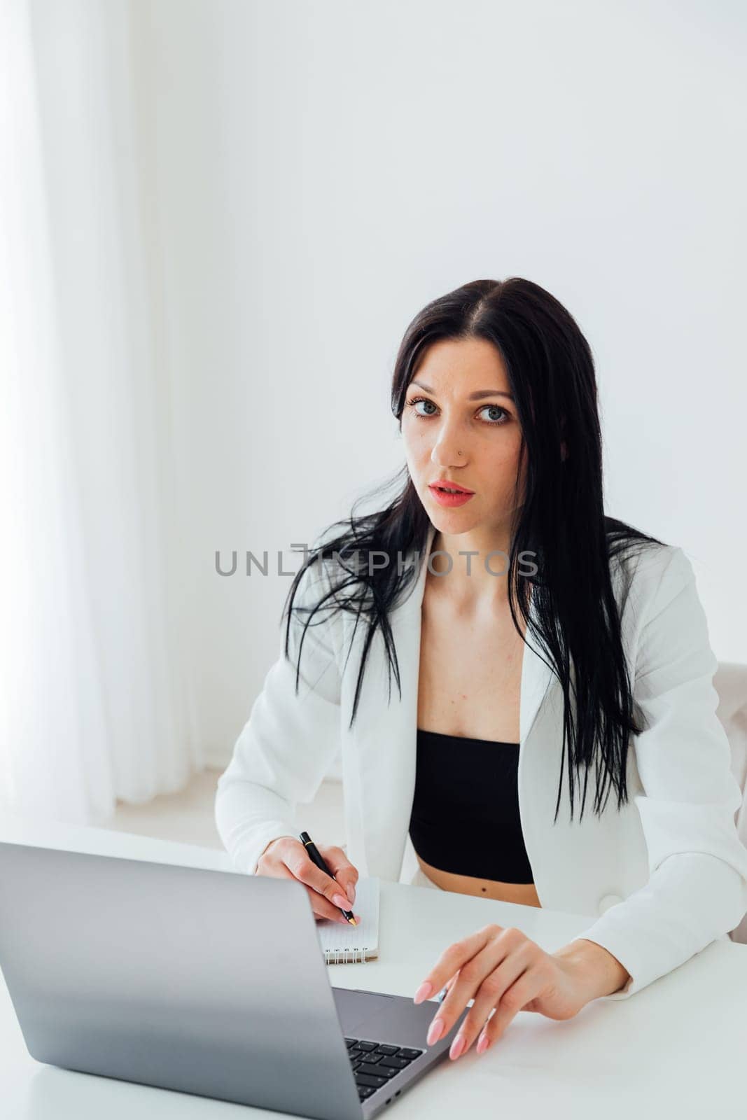Woman in business suit working on laptop small business online office