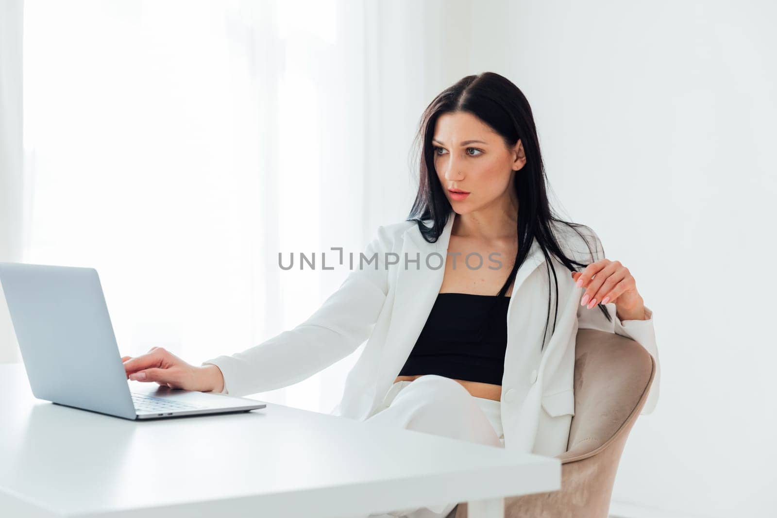 Woman in business suit working on laptop small business online office