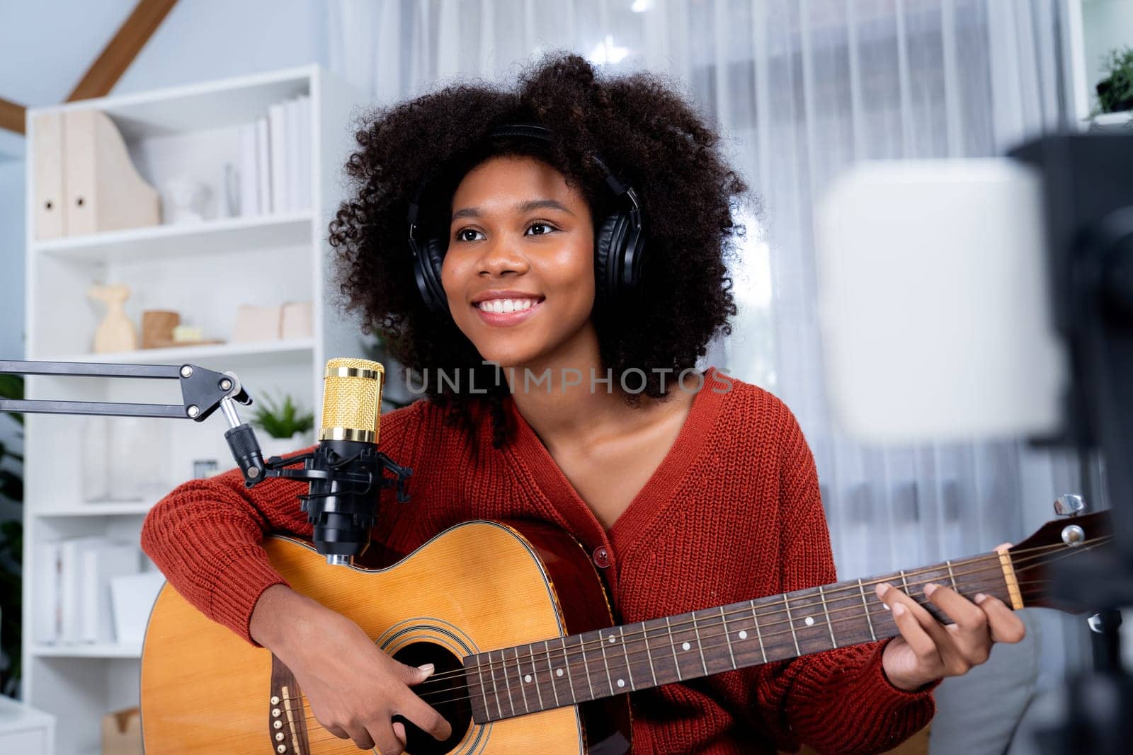 Host channel of African woman guitarist in broadcast on smartphone. Tastemaker. by biancoblue