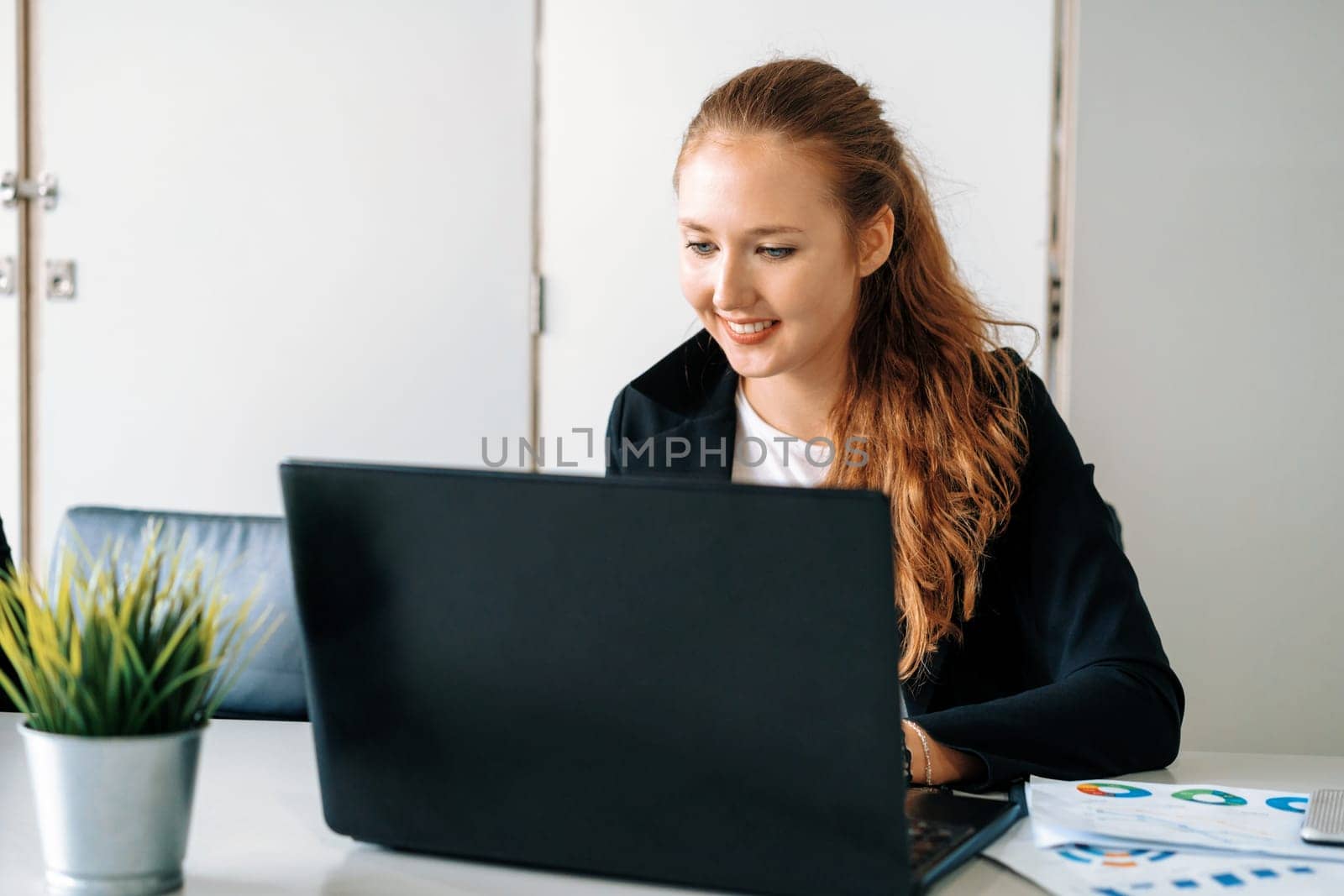 Young businesswoman work using laptop computer at the office desk. Business internet concept. uds