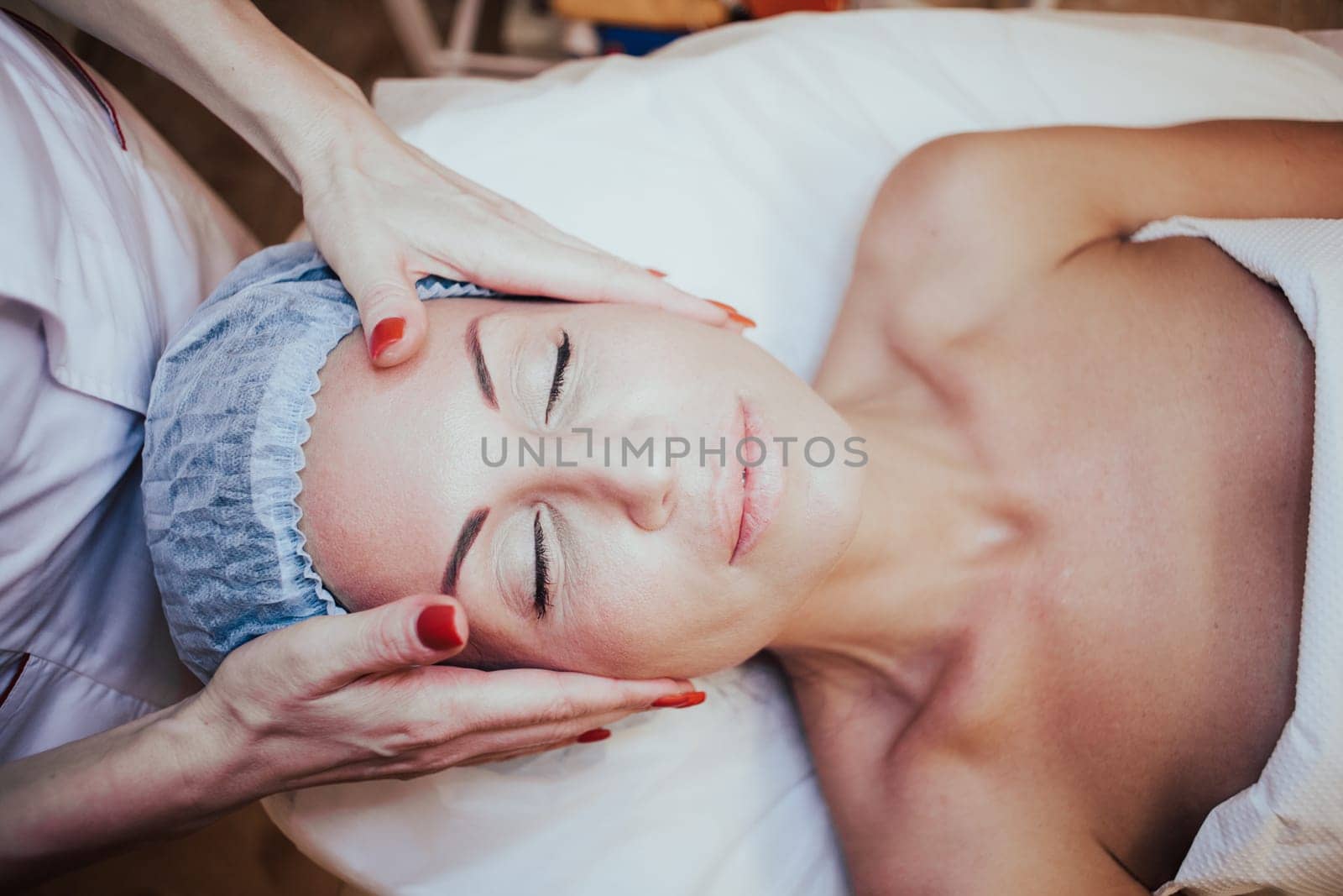 Cosmetology doctor makes woman treatments facial massage 1