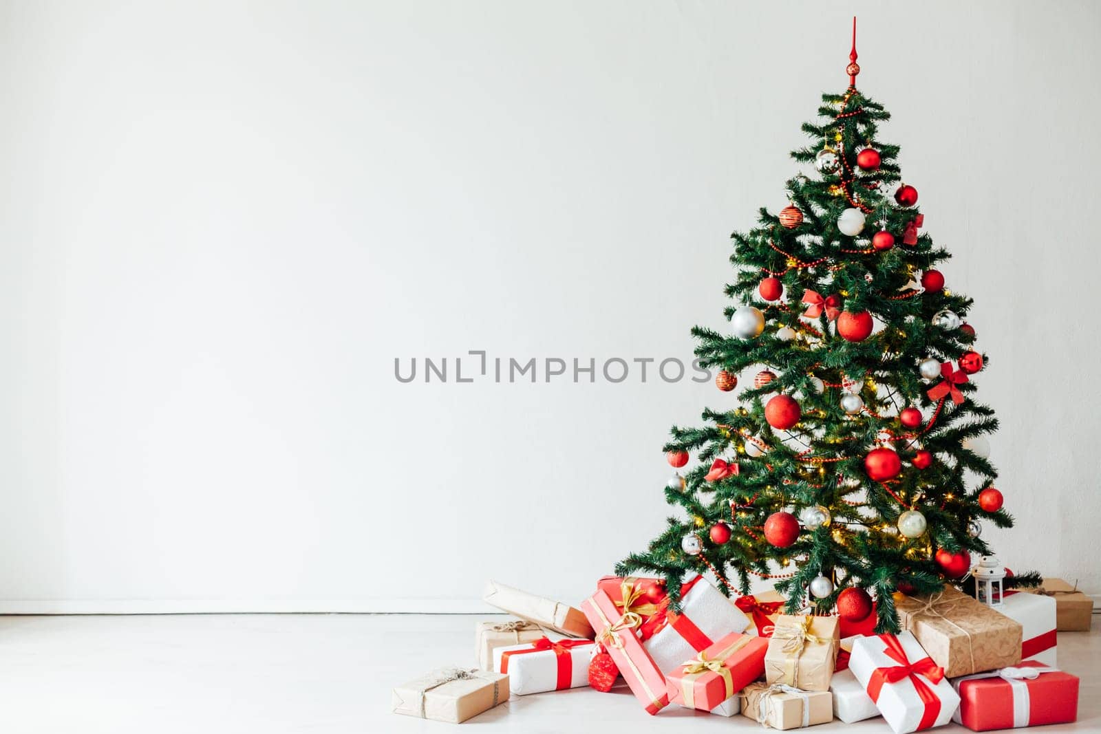 Christmas tree with red decor gifts for the new year holiday winter by Simakov