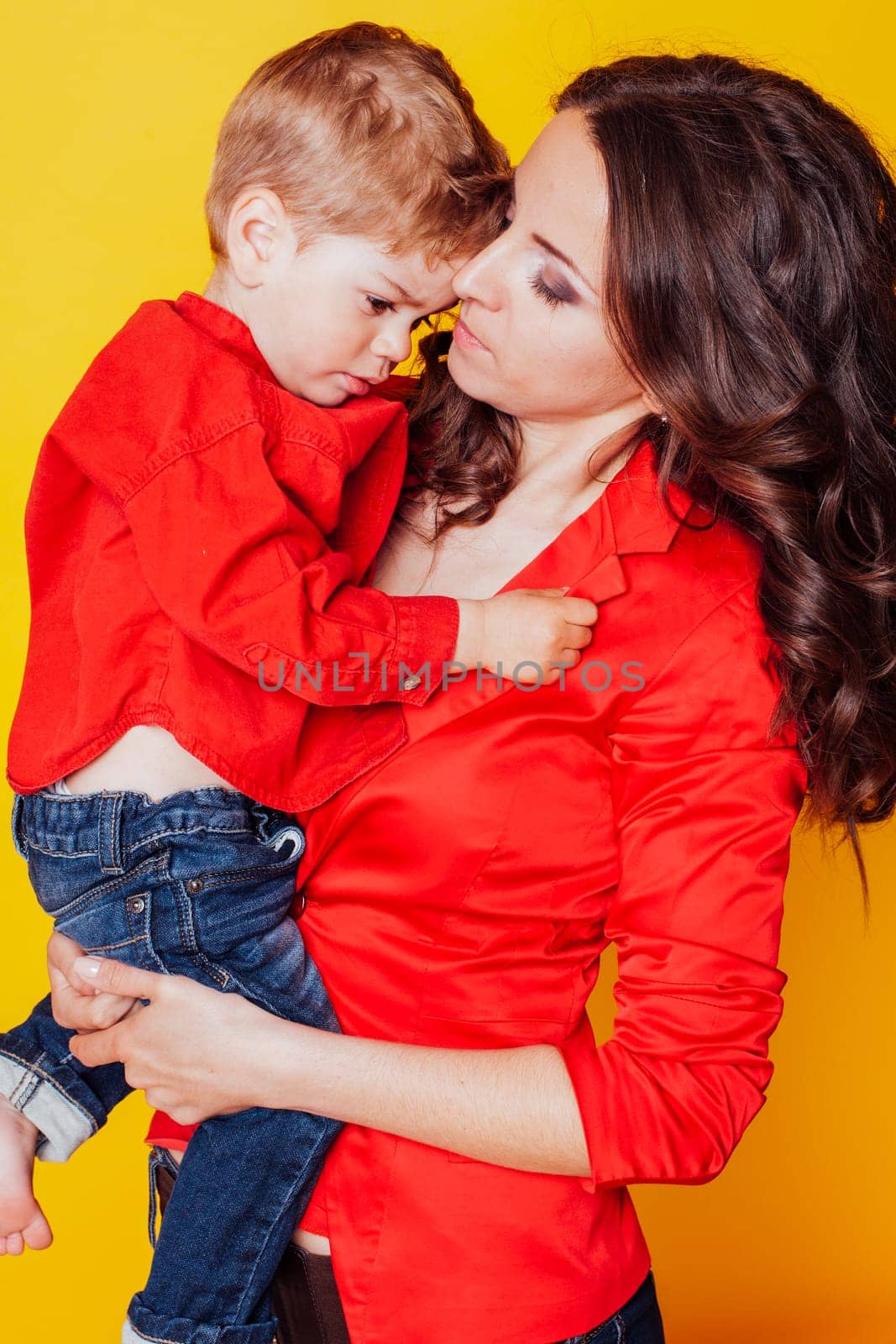 mother and son in red shirts on a yellow background