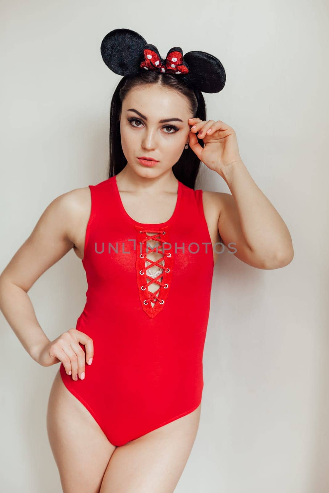 fashionable girl in red body posing on grey background 1
