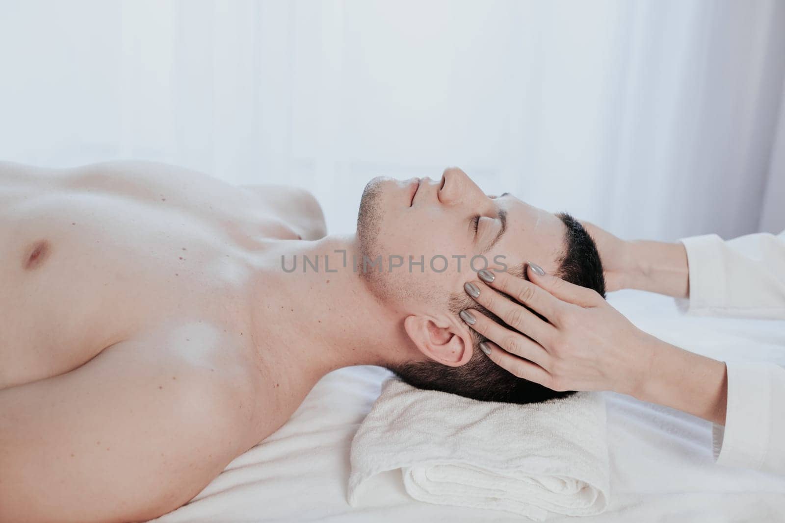 male masseuse makes a therapeutic massage in the Spa