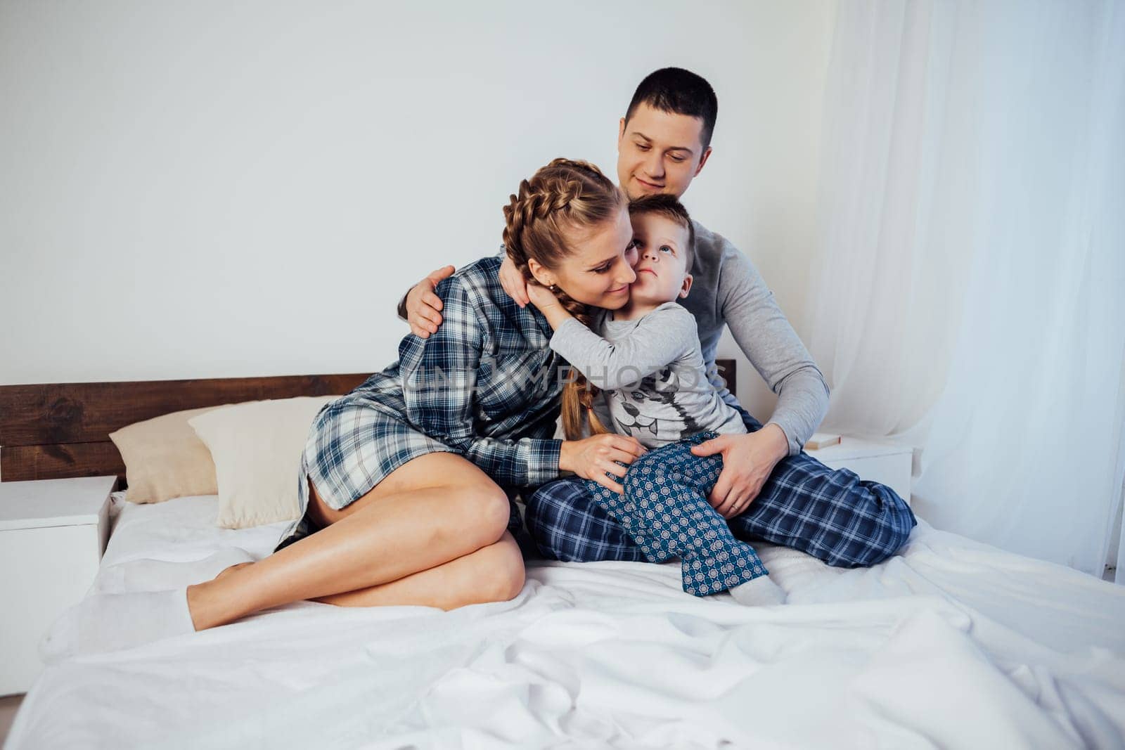 mom and dad and little boy in the bedroom by Simakov