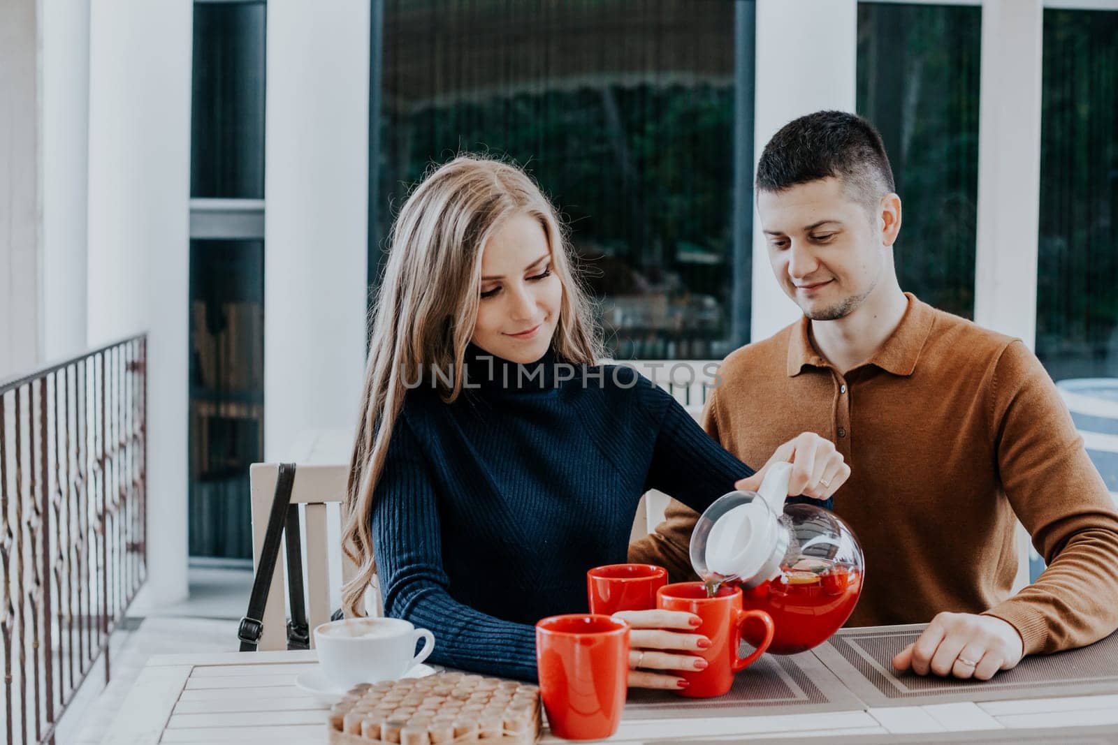 husband with wife on holiday drink hot coffee and tea by Simakov