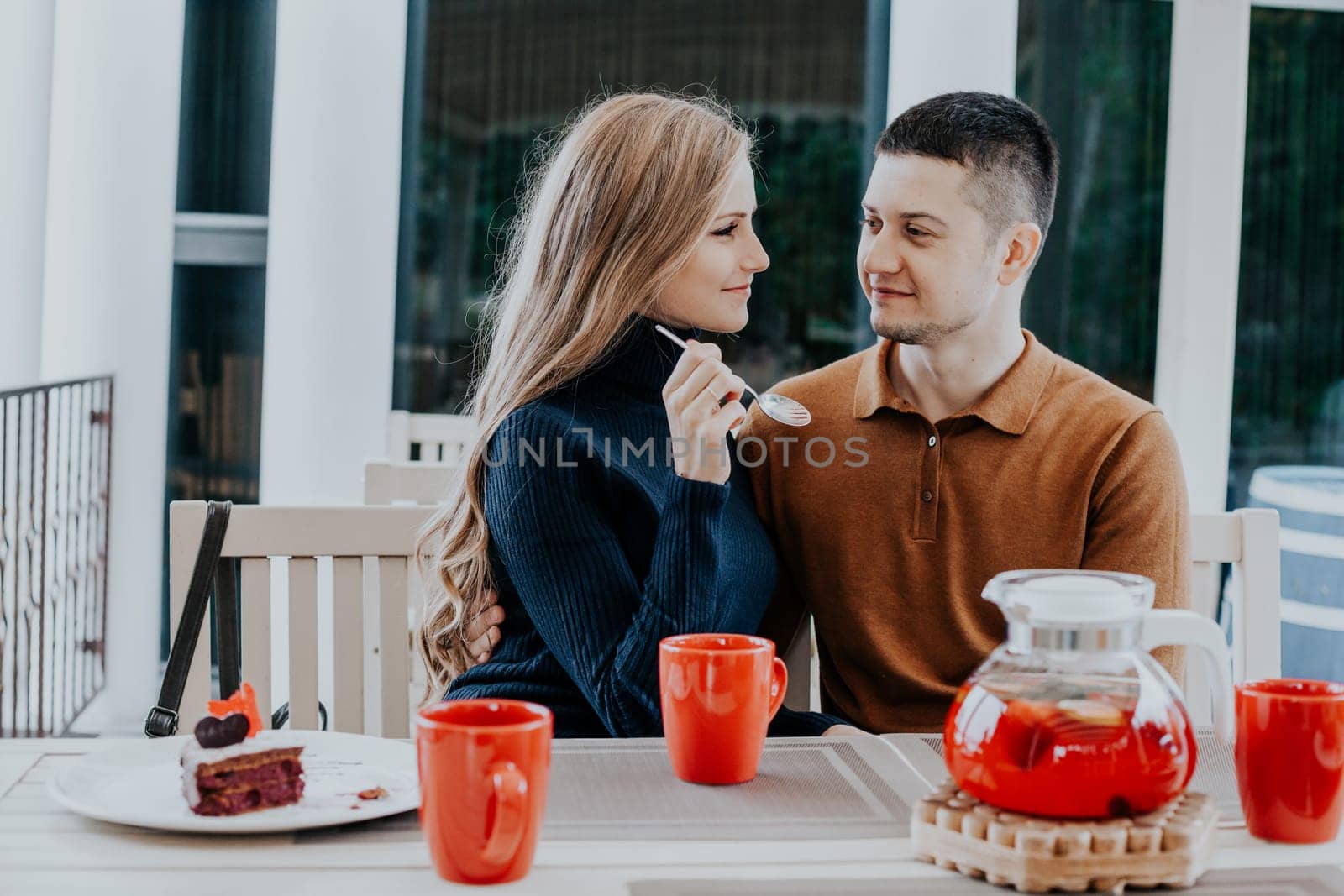 husband with wife on holiday drink hot coffee and tea by Simakov