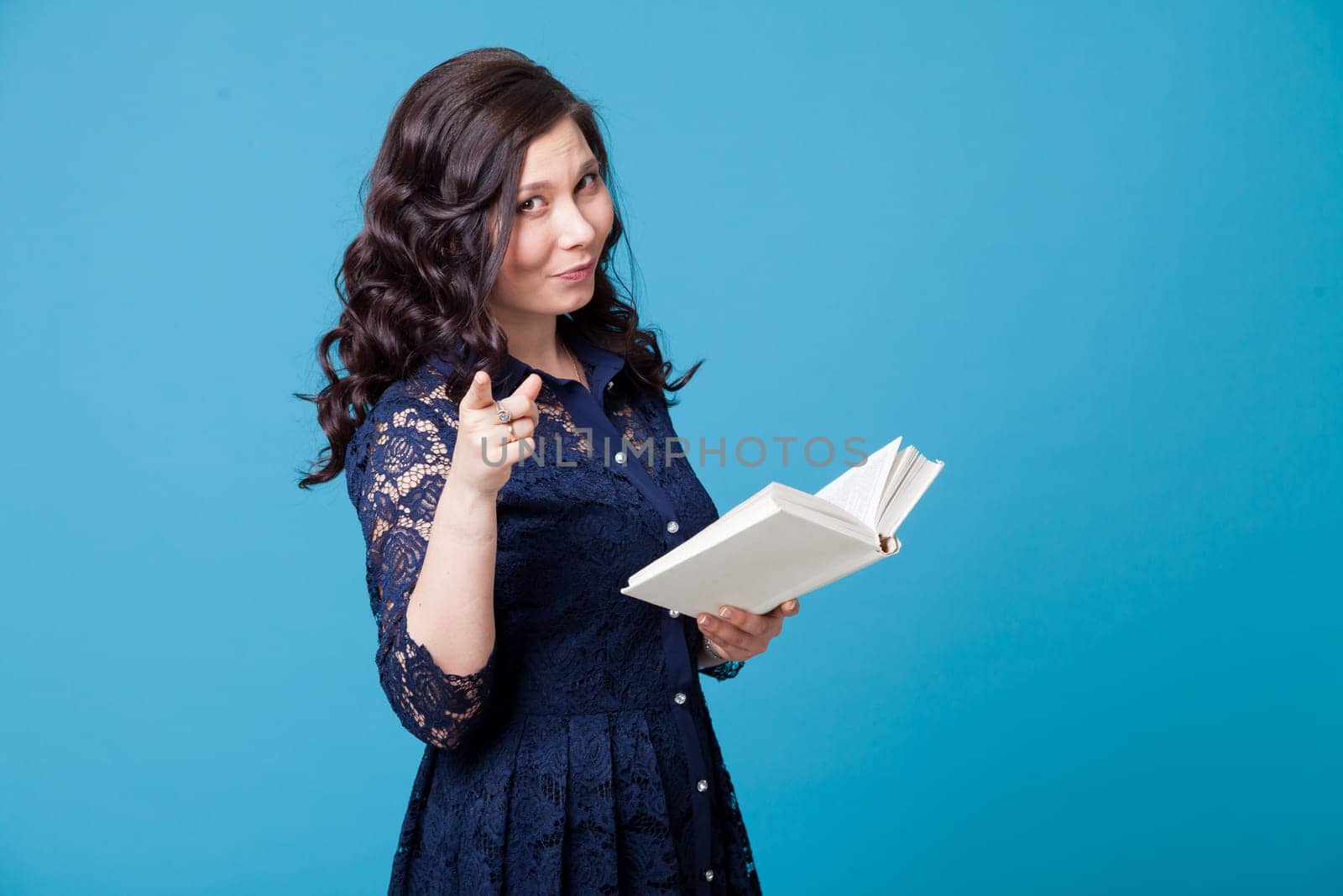 Beautiful fashionable asian woman reads a white book by Simakov
