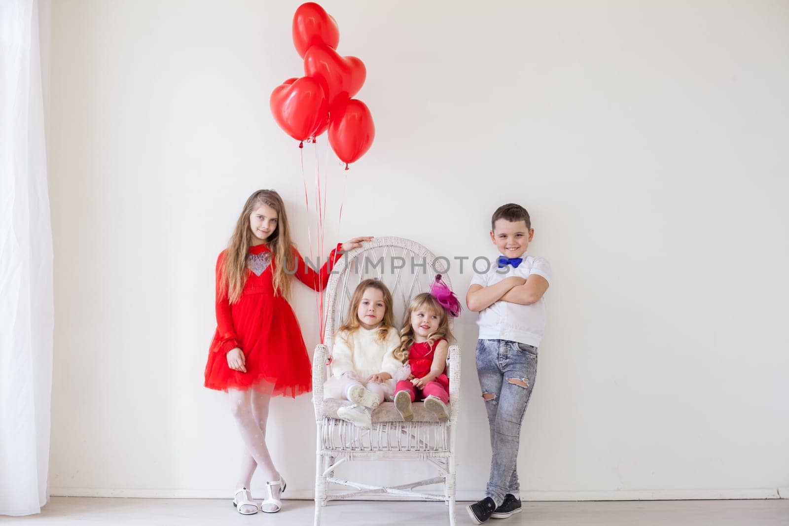 Boy and girls friends on red white birthday party by Simakov
