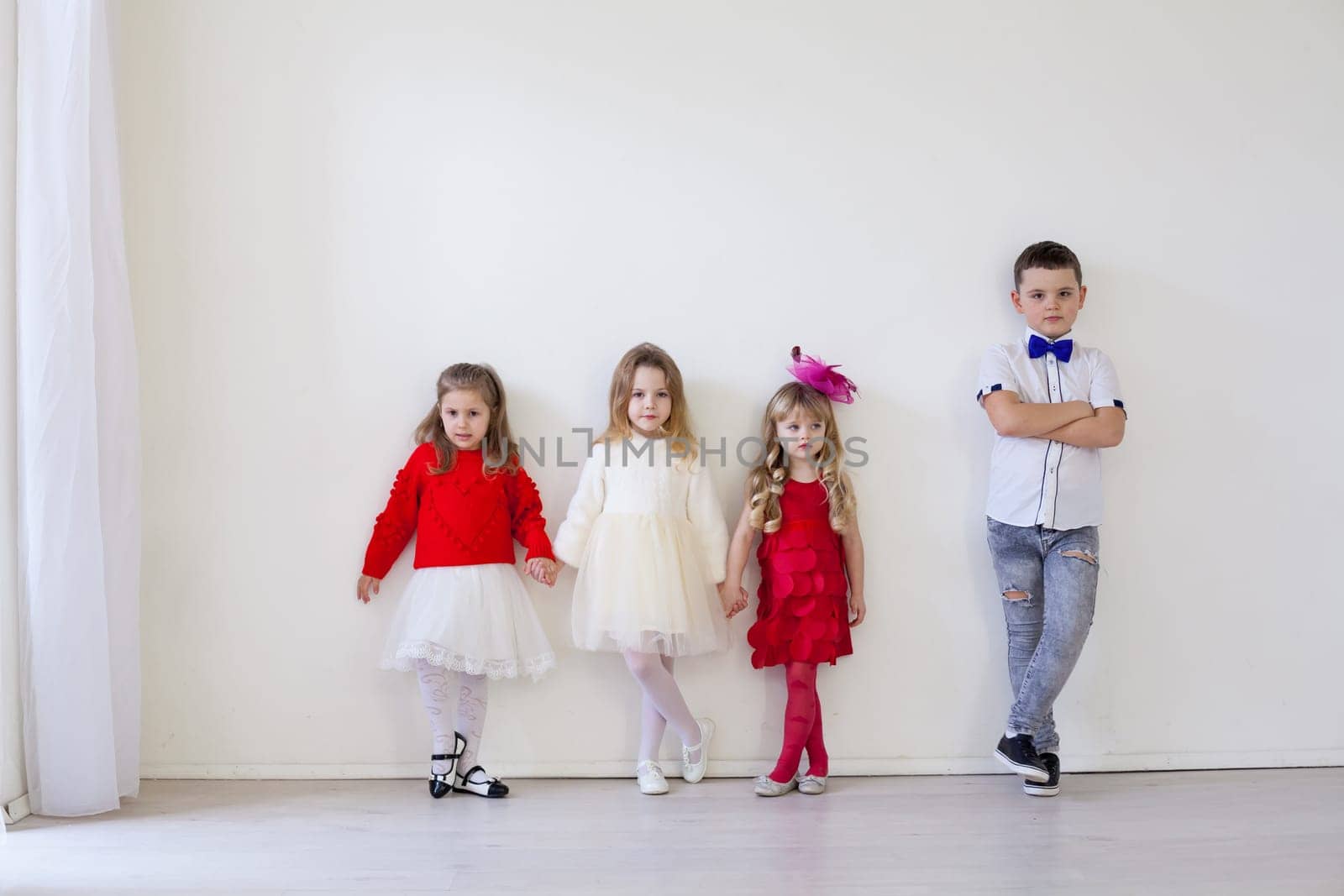 Boy and girls friends on red white birthday party by Simakov