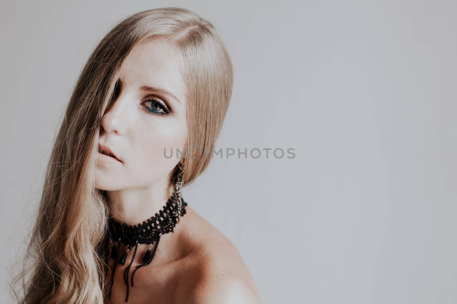 Portrait of a beautiful fashionable blonde woman with black clothes by Simakov
