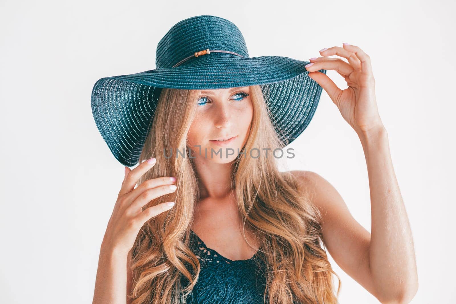 portrait of a beautiful blonde woman with a black hat with fields