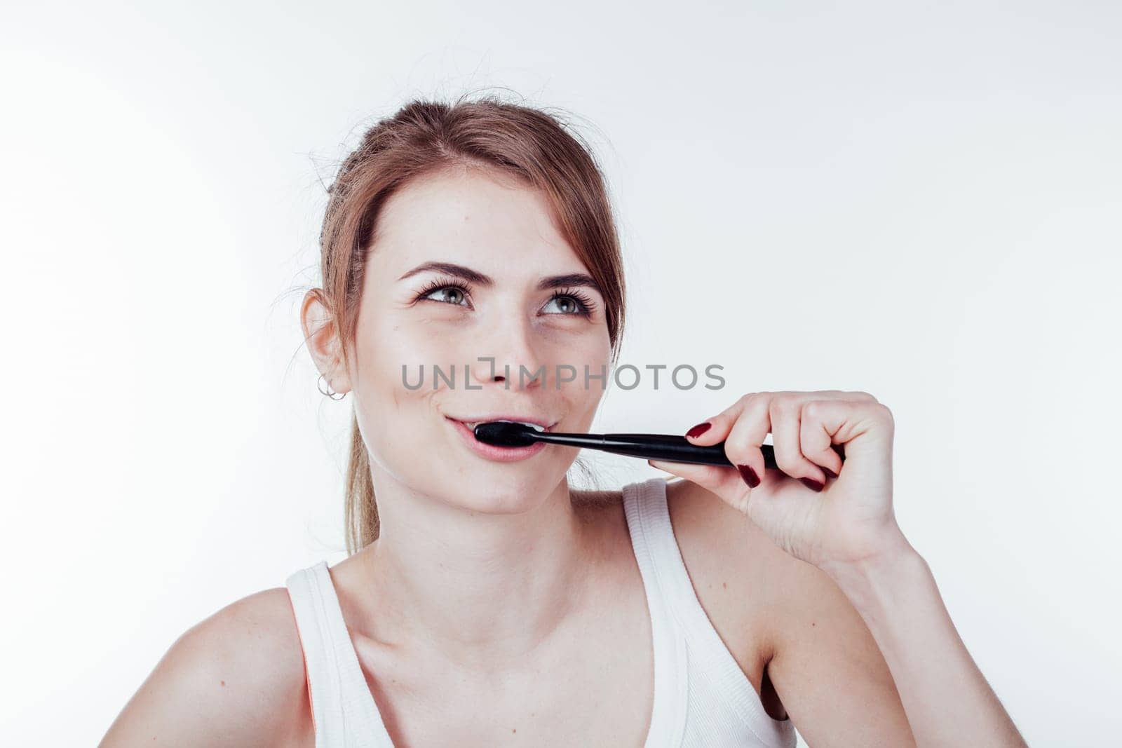 beautiful girl cleans white teeth toothbrush