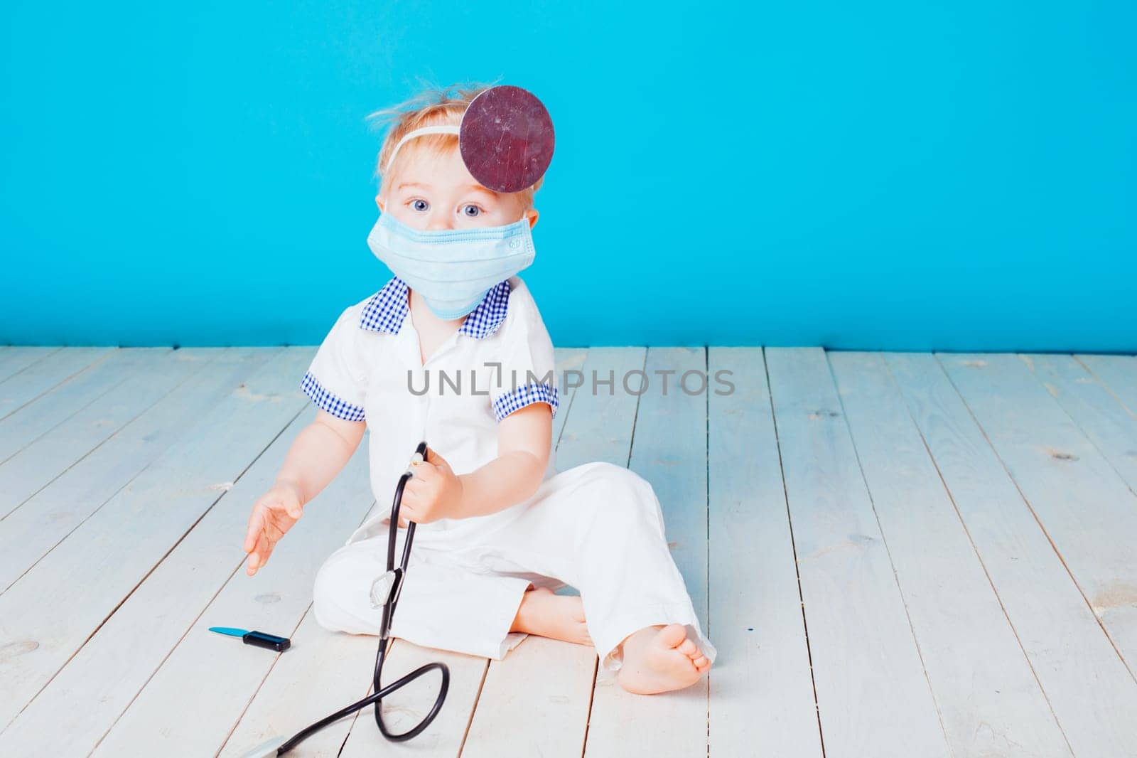 a little boy dressed as a doctor in the hospital
