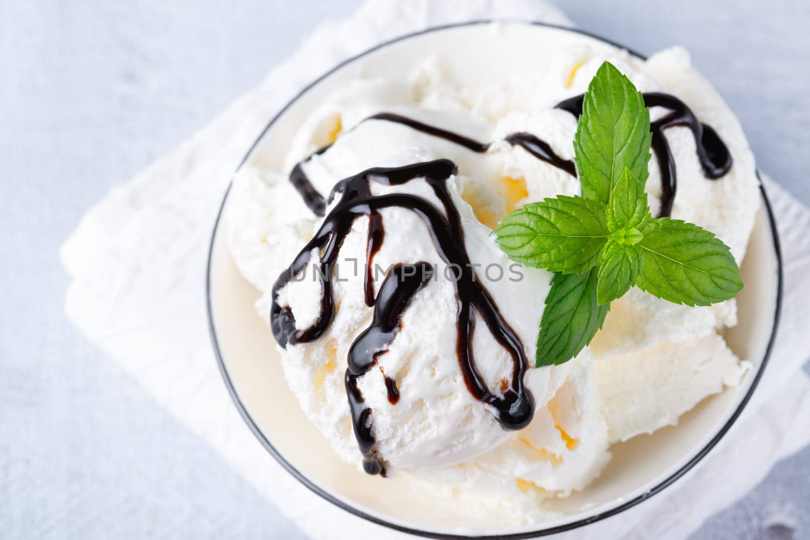 Bowl of vanilla ice cream isolated on white background.