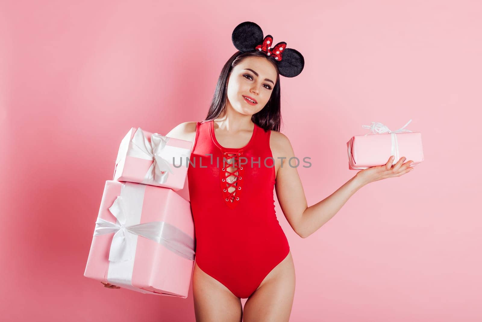 beautiful girl with pink presents for the holiday by Simakov