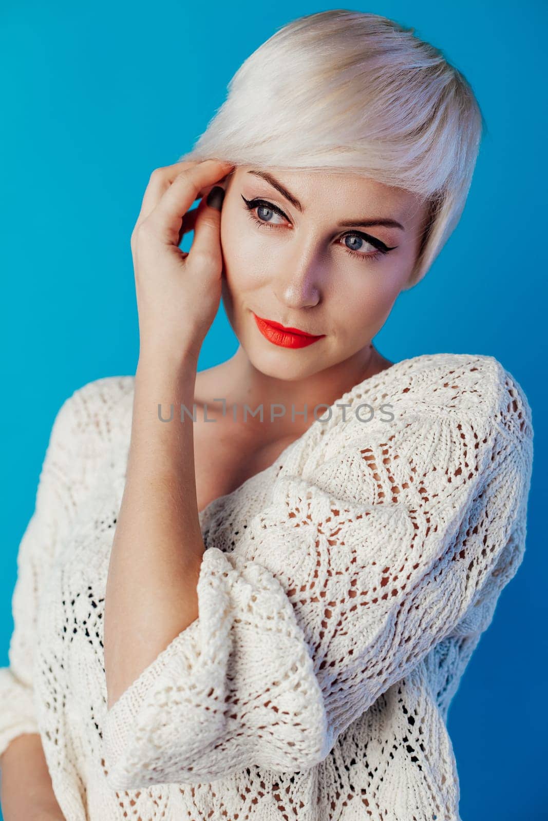Portrait of blonde with short hair on a blue background 1