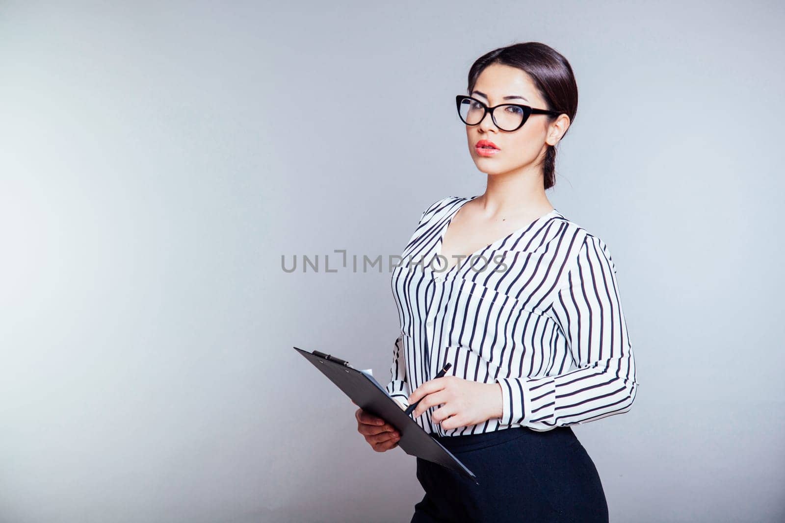 business girl in glasses works in the Office by Simakov