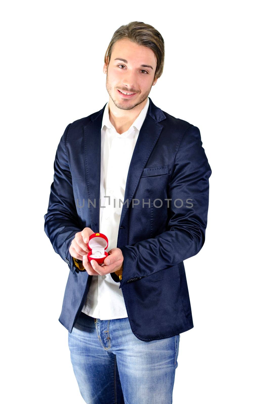 A man in a blue jacket holding a red box with an engament ring, proposing