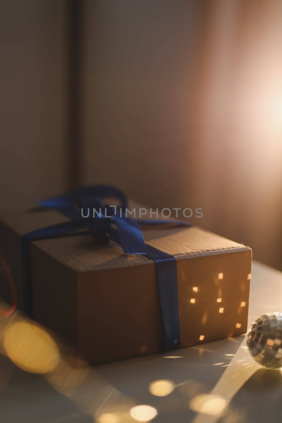 Gift box wrapped in craft paper with blue ribbon. High quality photo