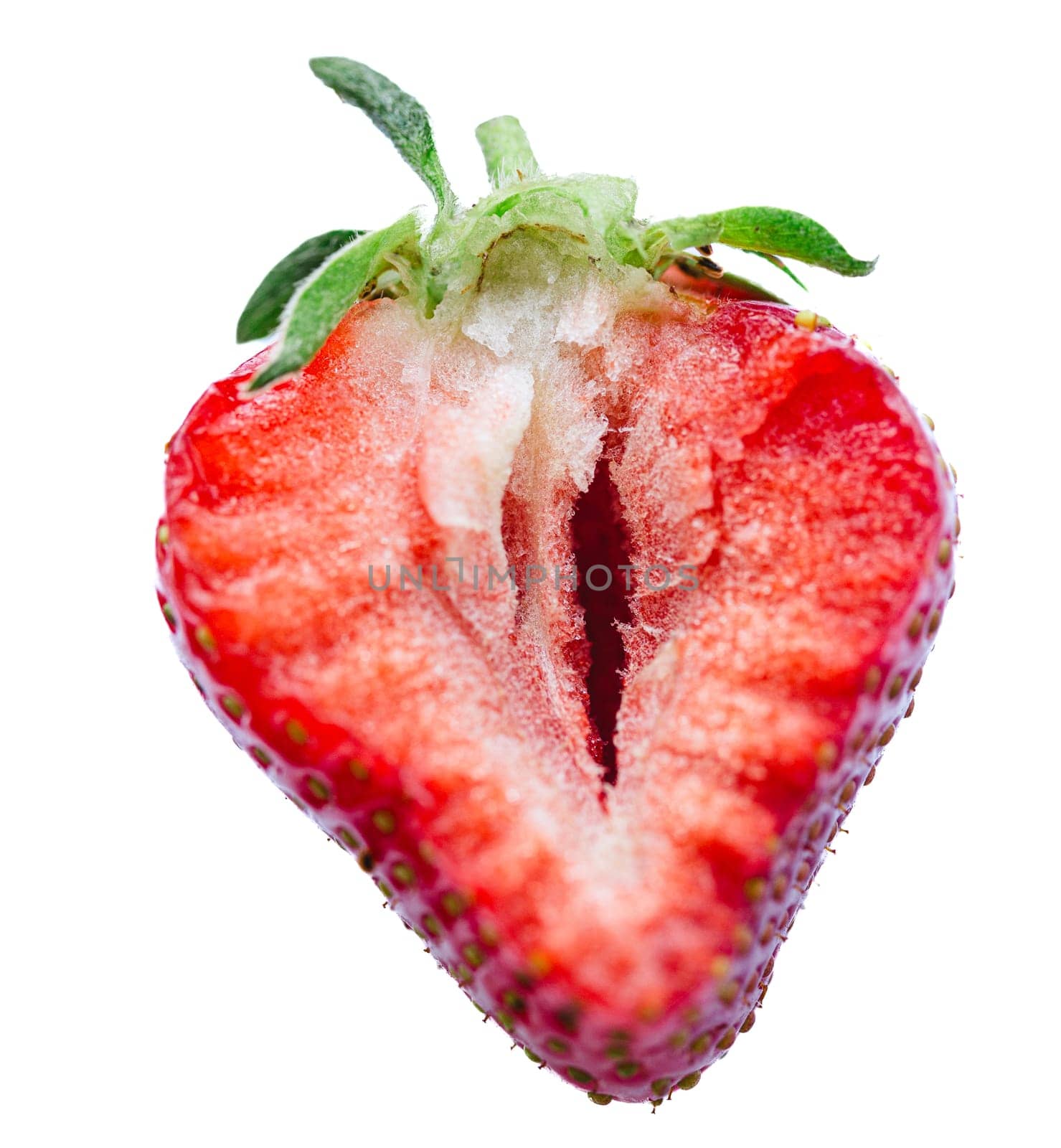 Ripe half of a strawberry on a white background. Shallow dof