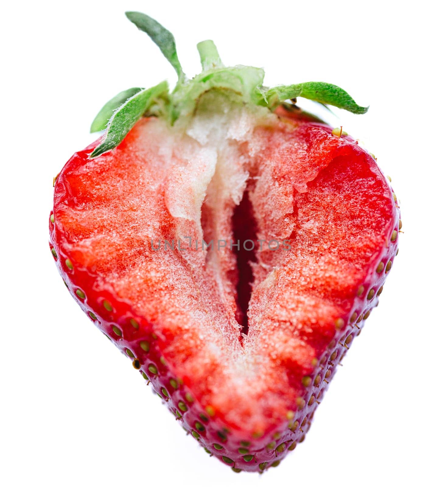 Ripe half of a strawberry on a white background. Shallow dof